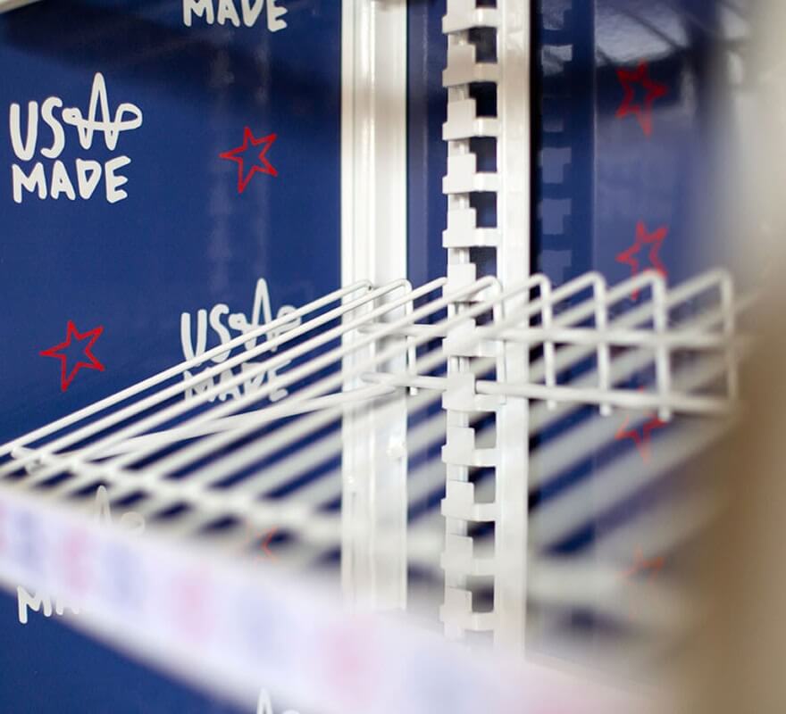 Close-up of white wire shelving rack with adjustable tiers